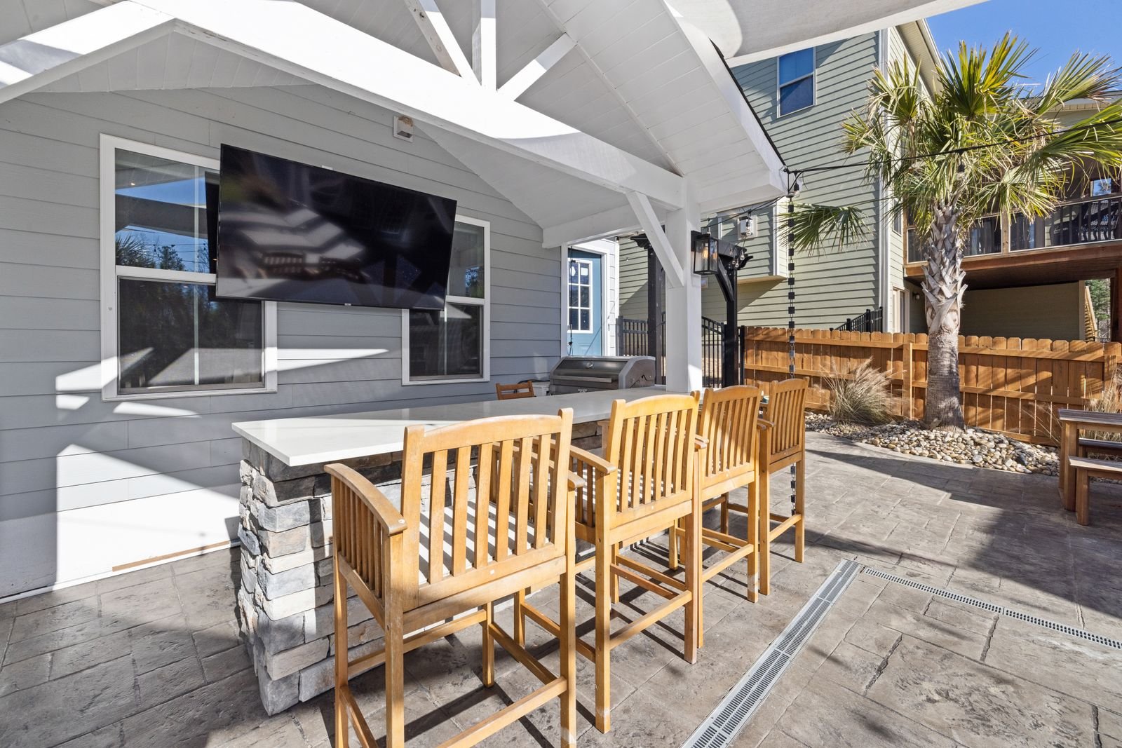 Covered patio with lounge seating beneath a solid roof